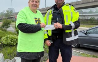 Sgt Scott presenting as cheque to MADD Saint John for Strides for Change